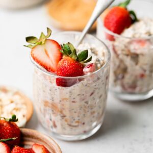 strawberry overnight oats in a glass cup