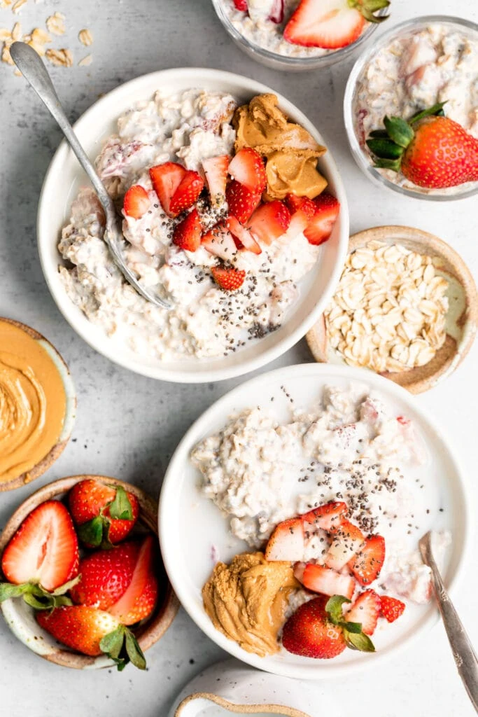 strawberry overnight oats in bowls with toppings