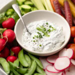 Greek Yogurt ranch dip with spoon and veggies