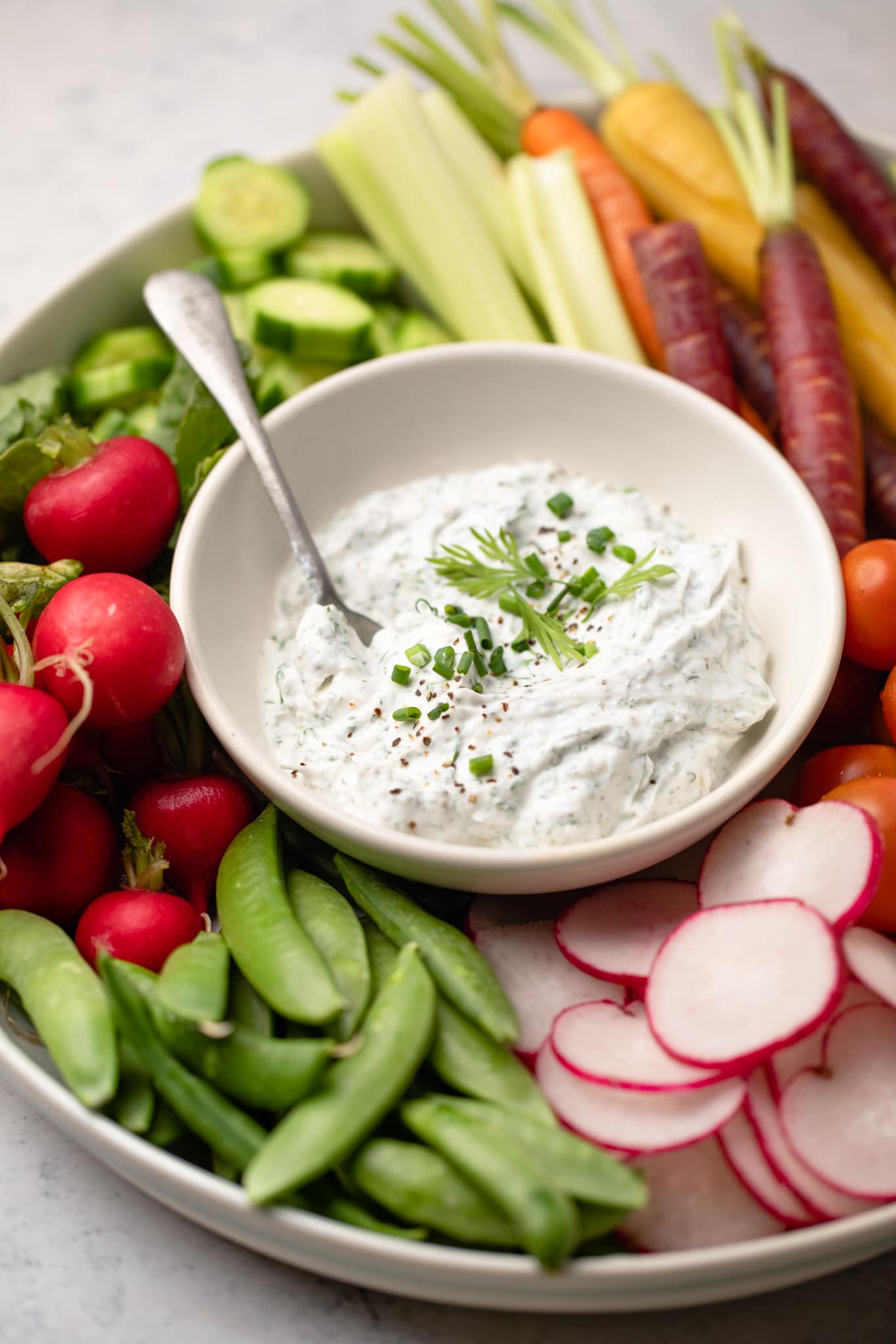 Greek Yogurt ranch dip with spoon and veggies
