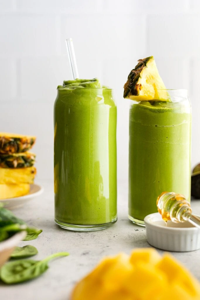green smoothie in two glasses with pineapple