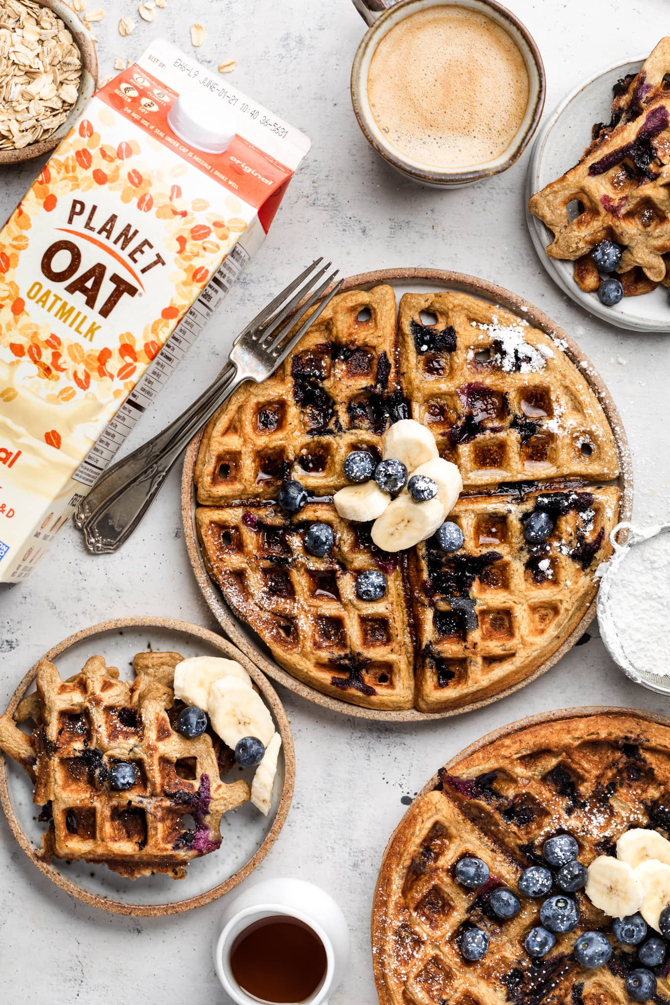 gluten free blueberry waffles on plates with coffee