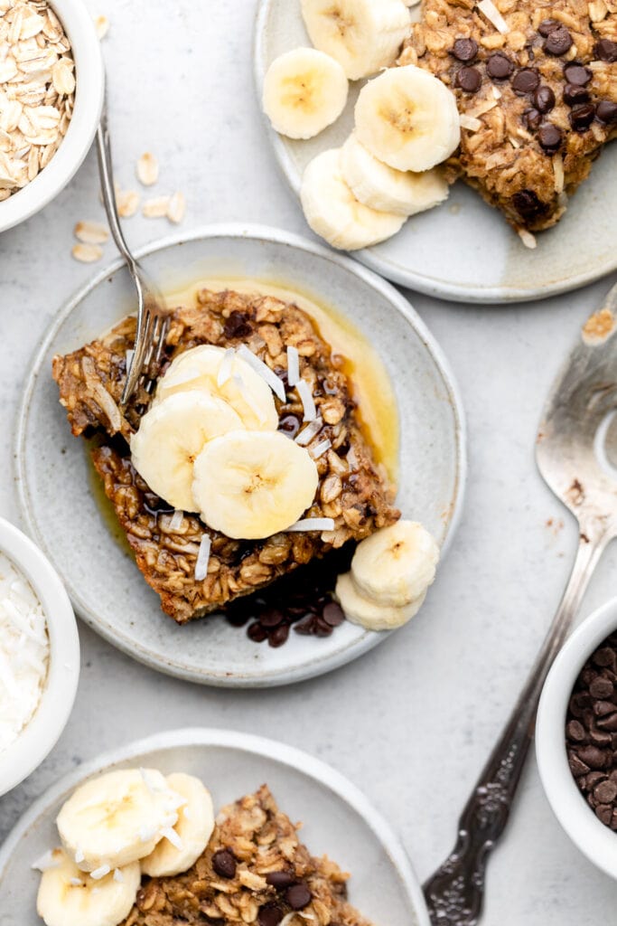 banana baked oatmeal on plate with fork topped with banana slices