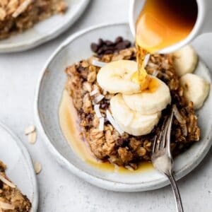 baked oatmeal with maple syrup drizzled on top