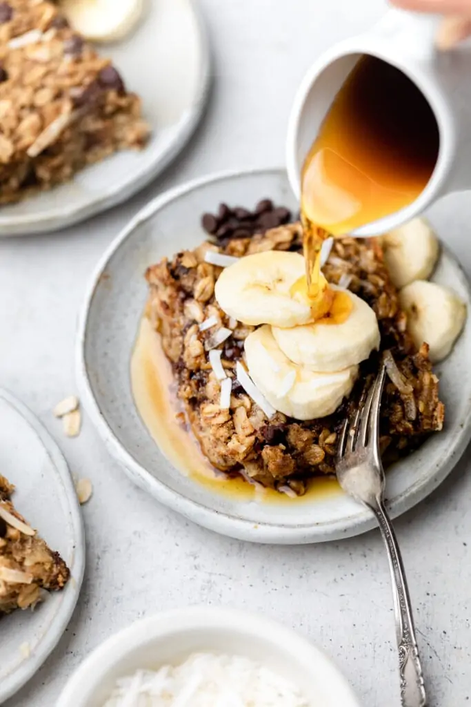 baked oatmeal with maple syrup drizzled on top