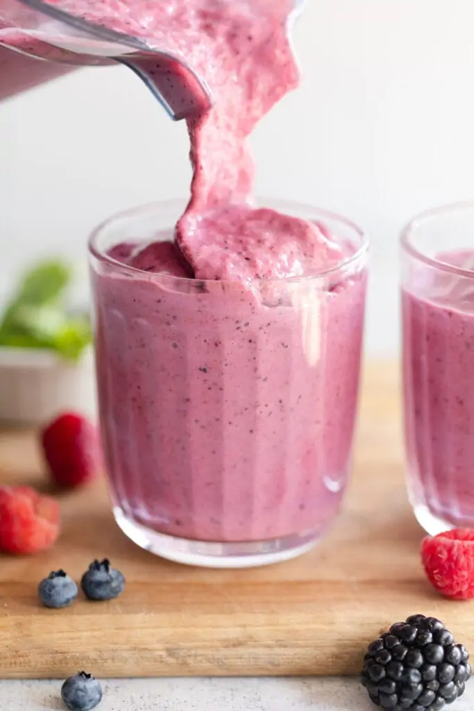 mixed berry smoothie poured into a glass