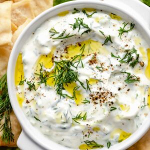 tzatziki sauce in bowl topped with herbs