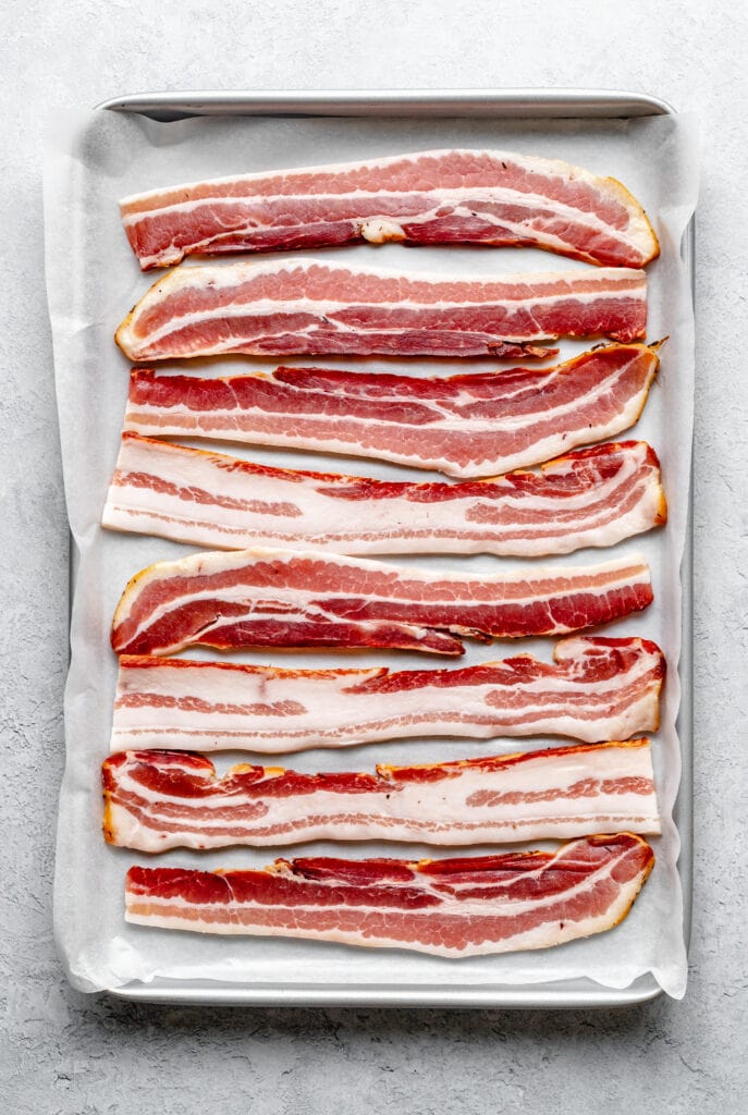 https://allthehealthythings.com/wp-content/uploads/2021/07/How-to-Bake-Bacon-in-the-Oven-2-1-687x1024.jpg