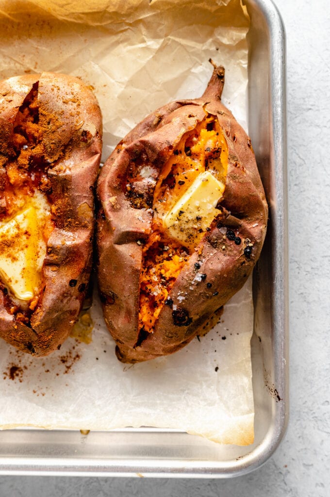 baked sweet potatoes with butter on sheet pan