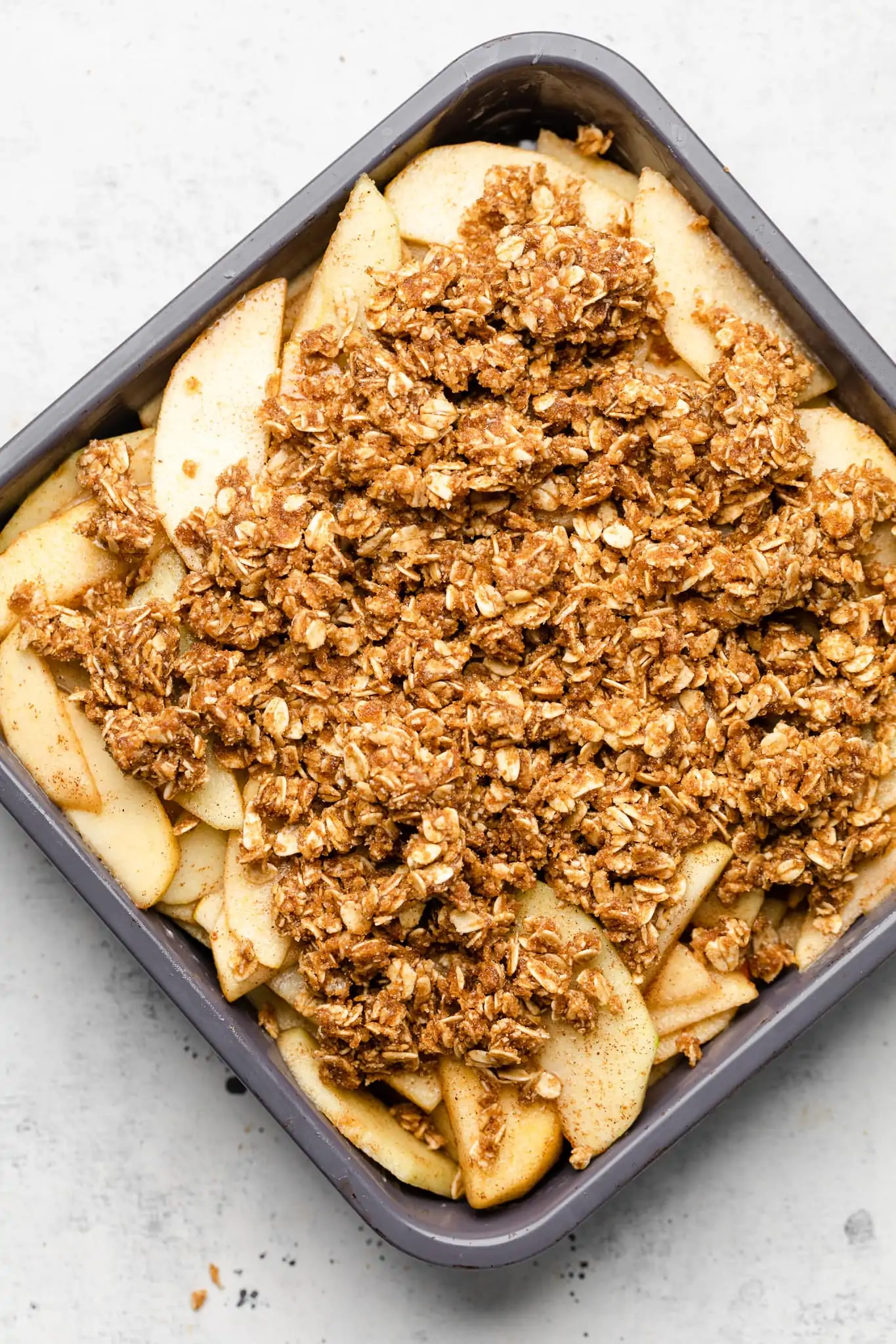 apple filling and apple crisp toping in a baking pan.