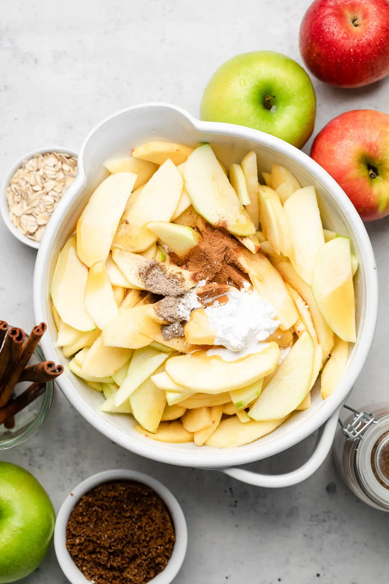 apples in a bowl with cinnamon, caradamom, and cornstarch