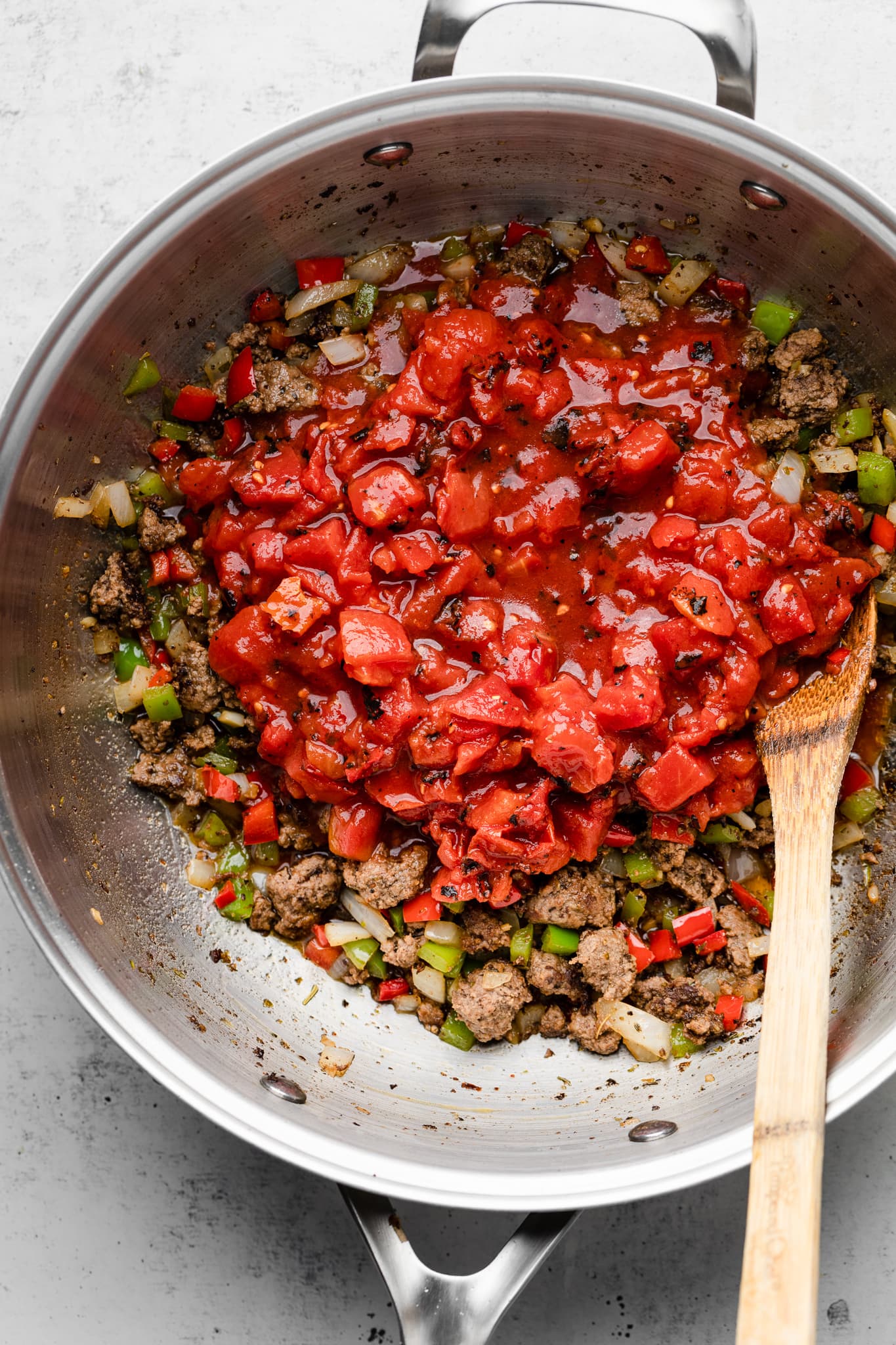 tomatoes in pot with ground beef and veggies