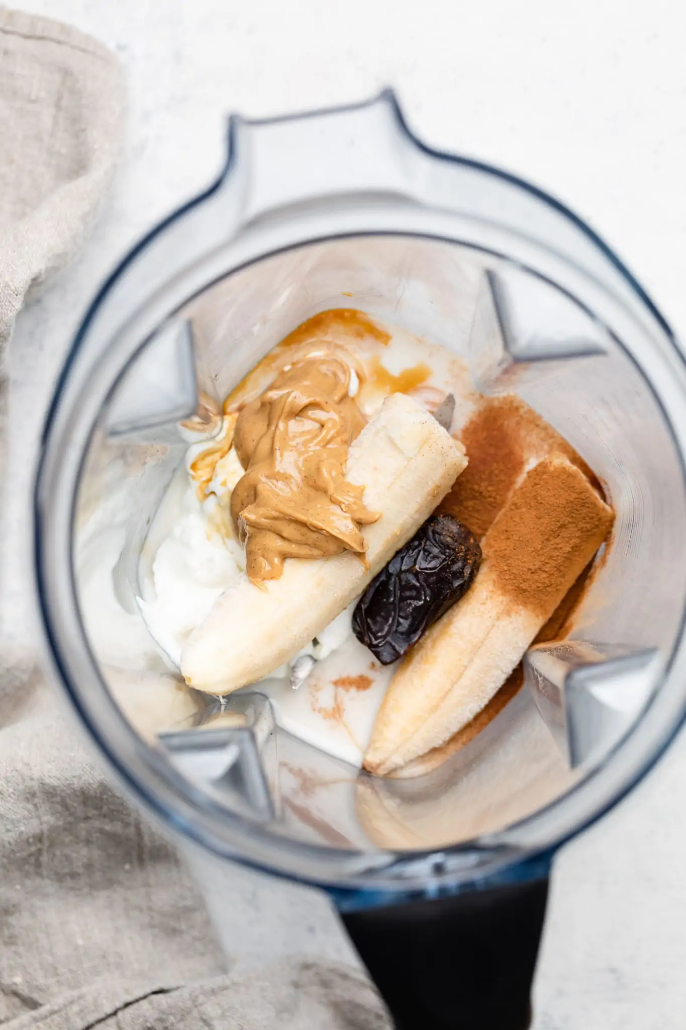 peanut butter banana smoothie ingredients in a blender