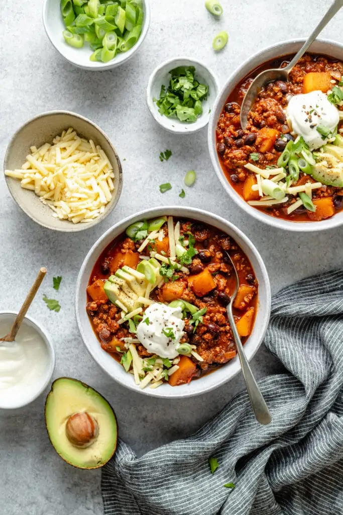 chili with toppings in two bowls