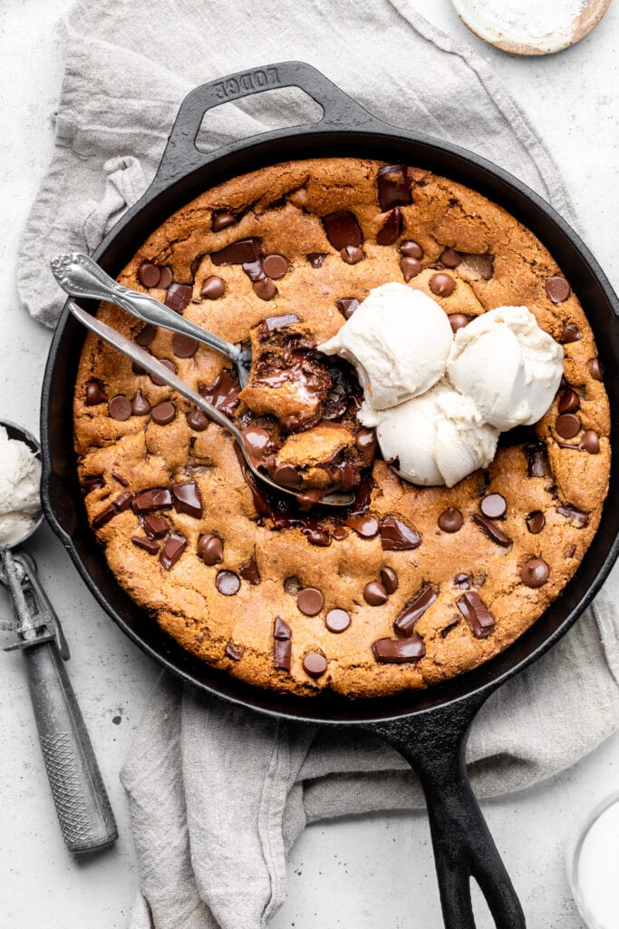 skillet cookie with ice cream and spoons