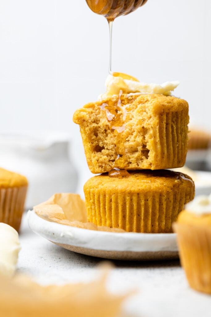 pumpkin cornbread muffins stacked on top of each other