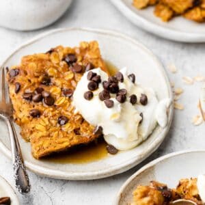 baked oatmeal on plate with whipped cream