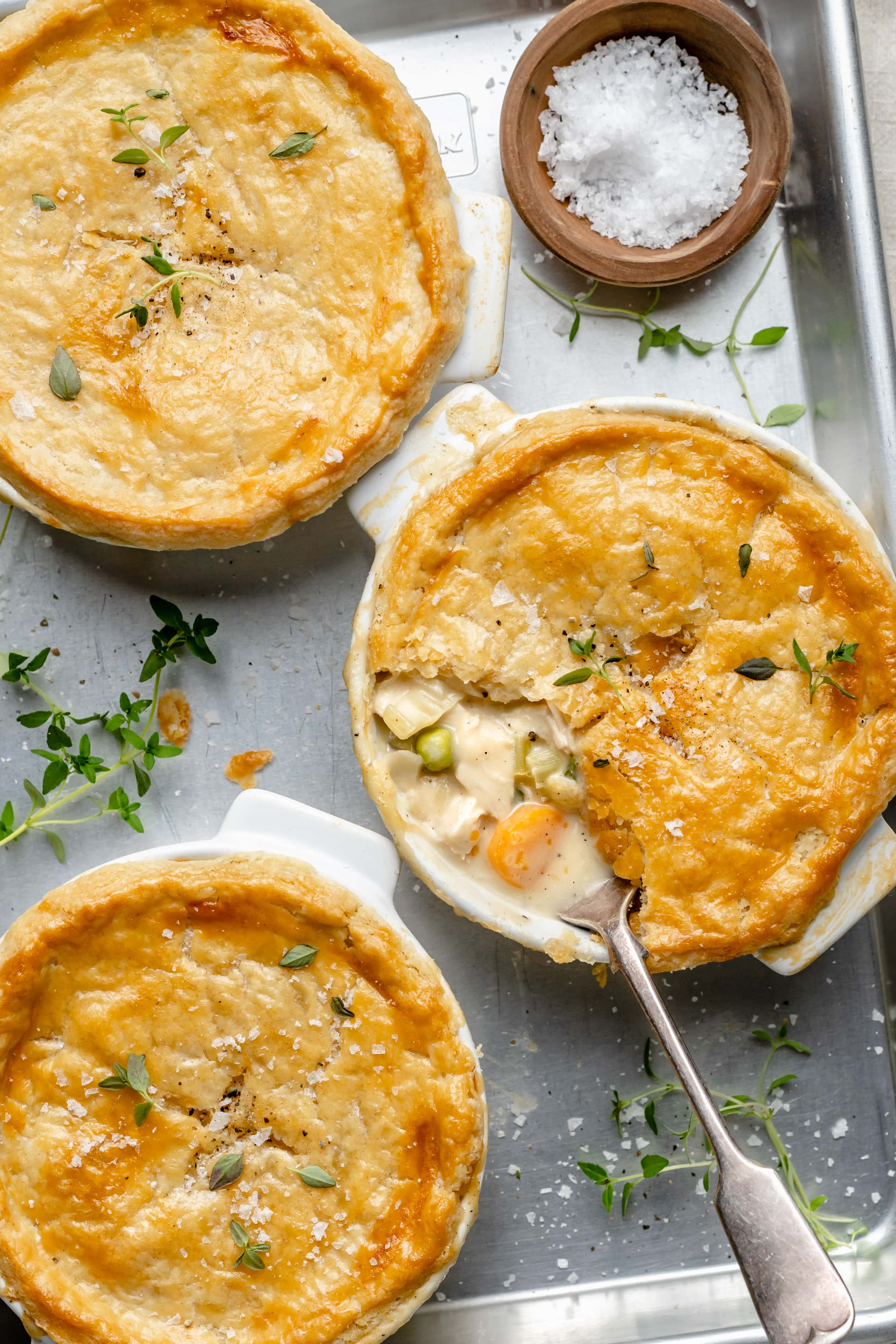 pot pies on sheet pan with spoon