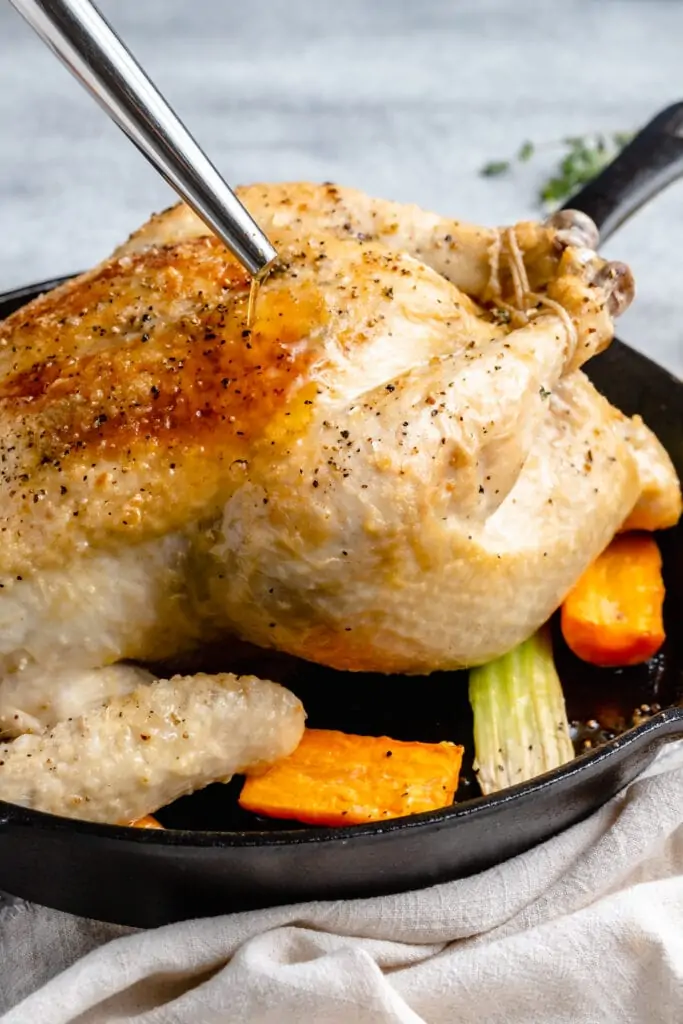 chicken roasting in pan and basted