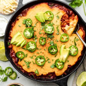 chili pie in skillet with toppings