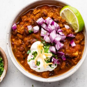 turkey pumpkin chili in bowl with toppings
