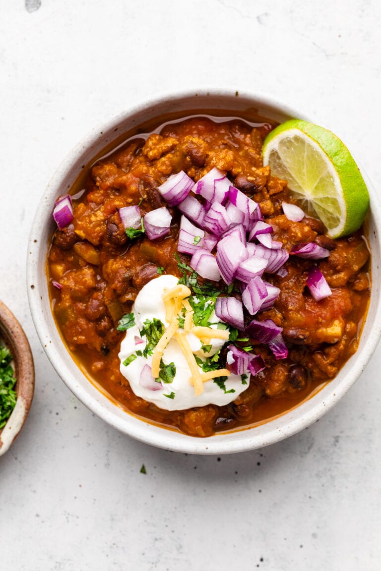 turkey pumpkin chili in bowl with toppings