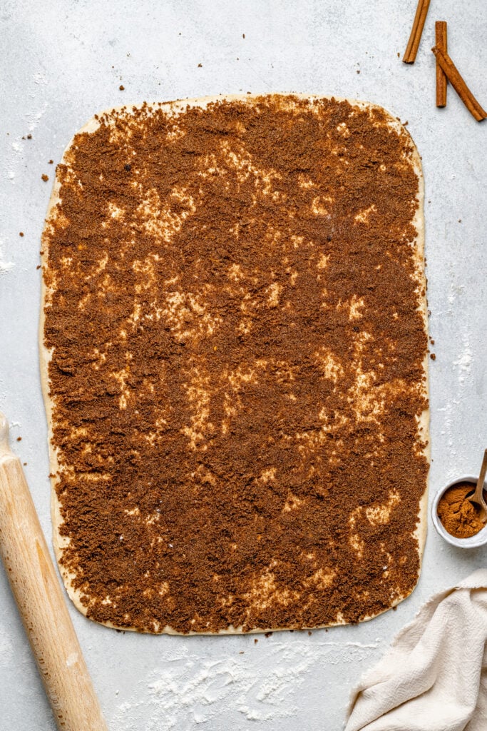 cinnamon sugar spread out on dough