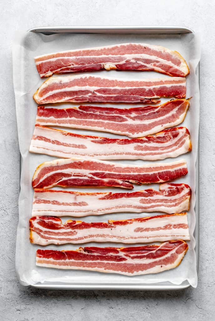 raw bacon on sheet pan