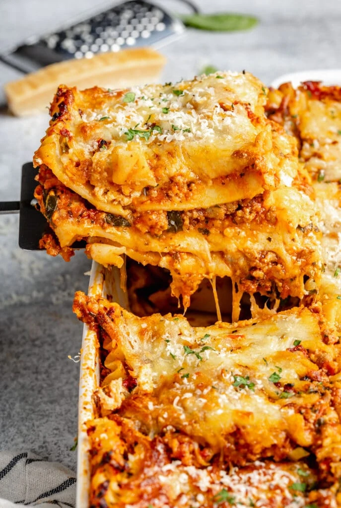 slice of lasagna being pulled out of pan