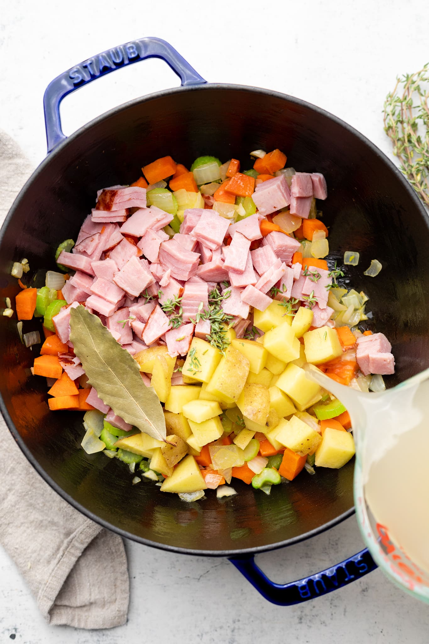 broth being poured into soup