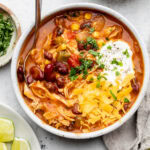 chicken enchilada soup in bowl with spoon