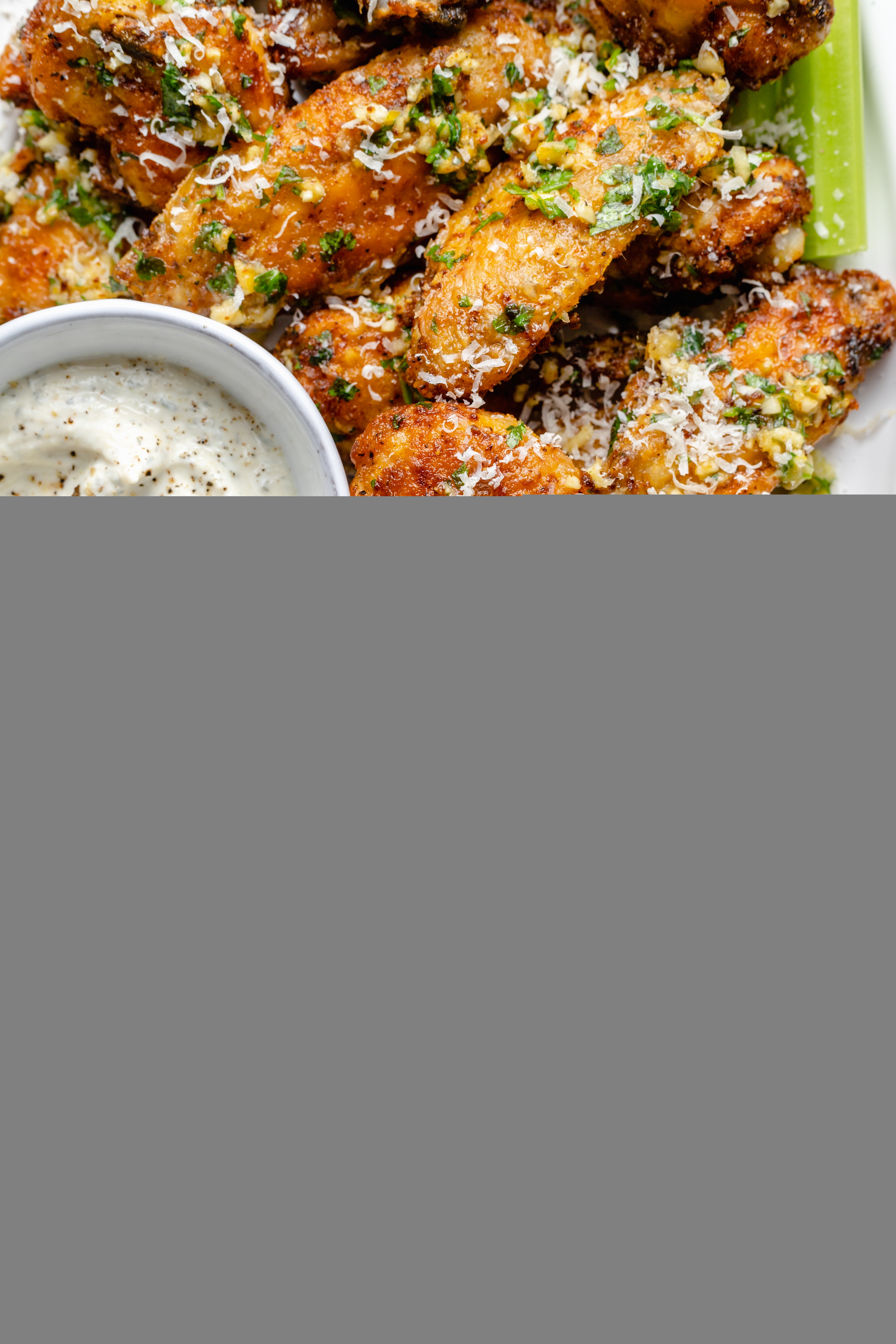 garlic parmesan wings on plate with dipping sauce
