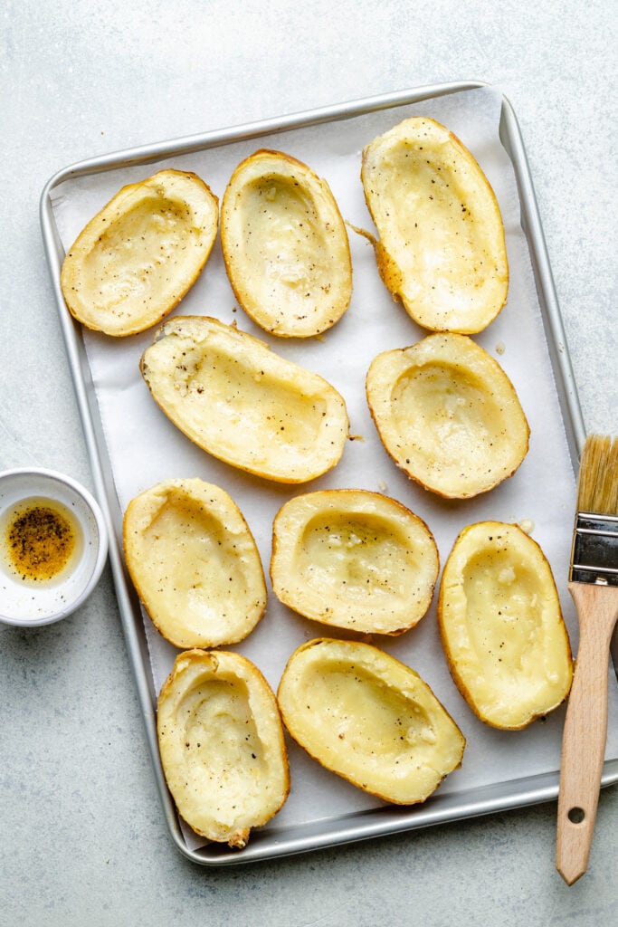 hollowed out potatoes on sheet pan