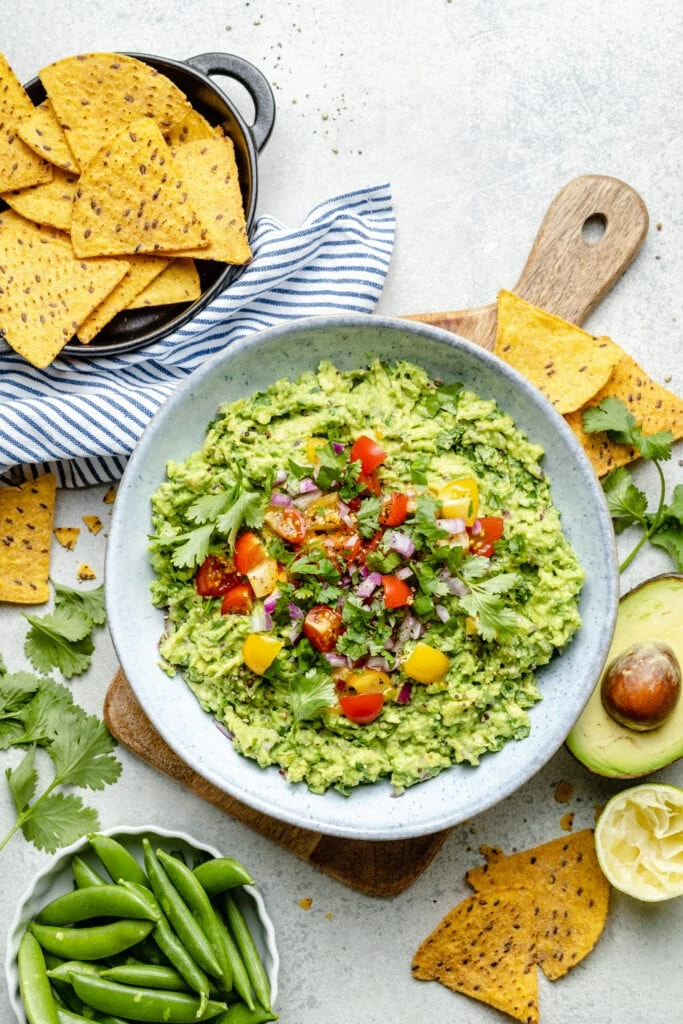 guacamole in bowl with tomato topping