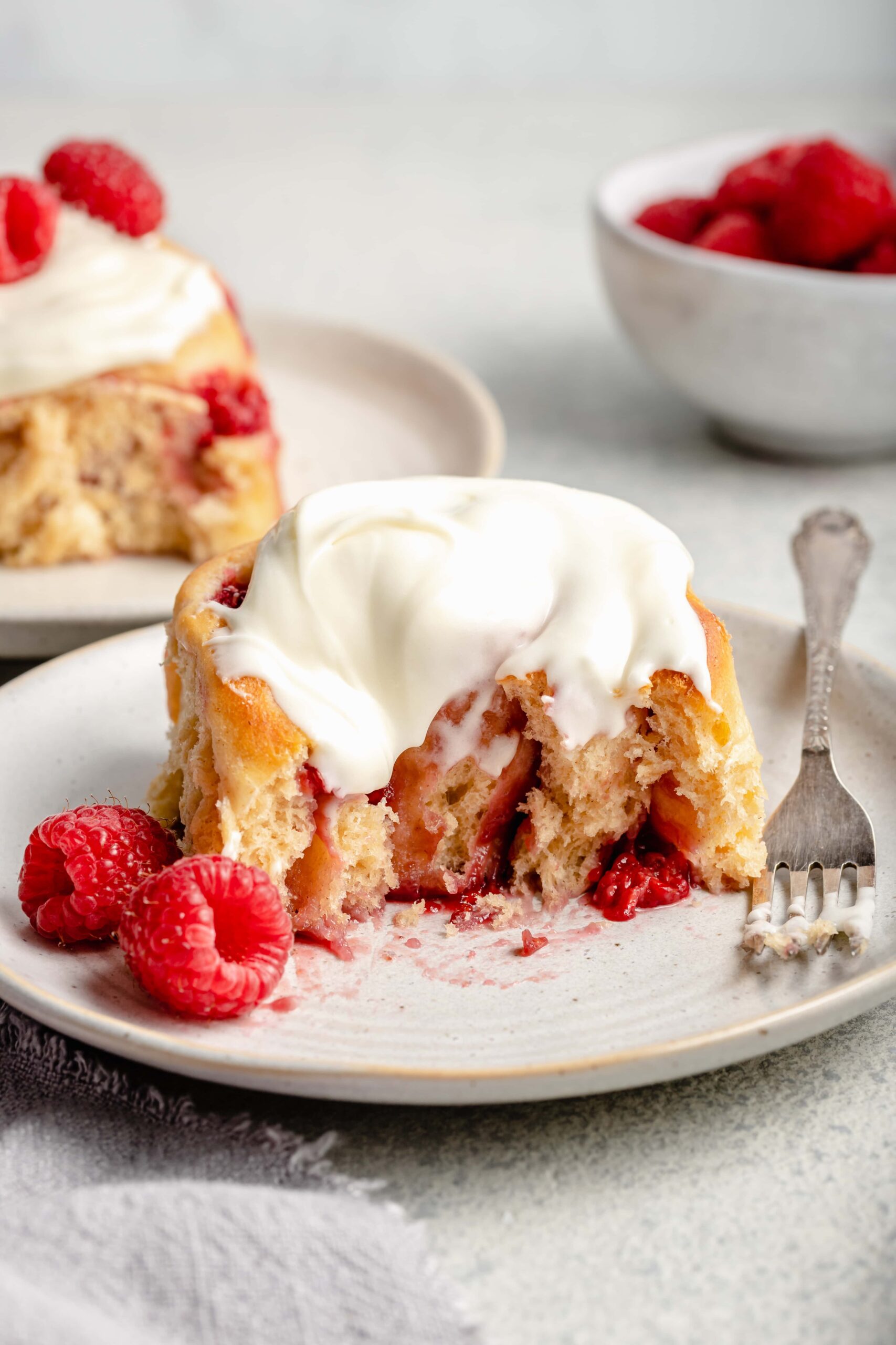 raspberry sweet roll on plate with fork
