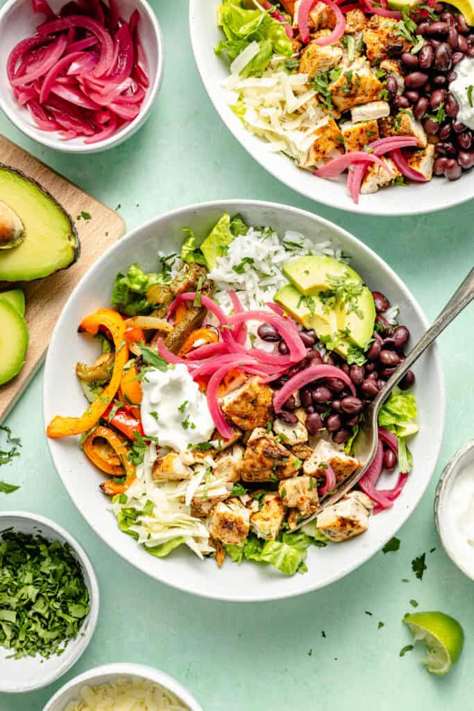 sheet pan chicken burrito bowl with fork