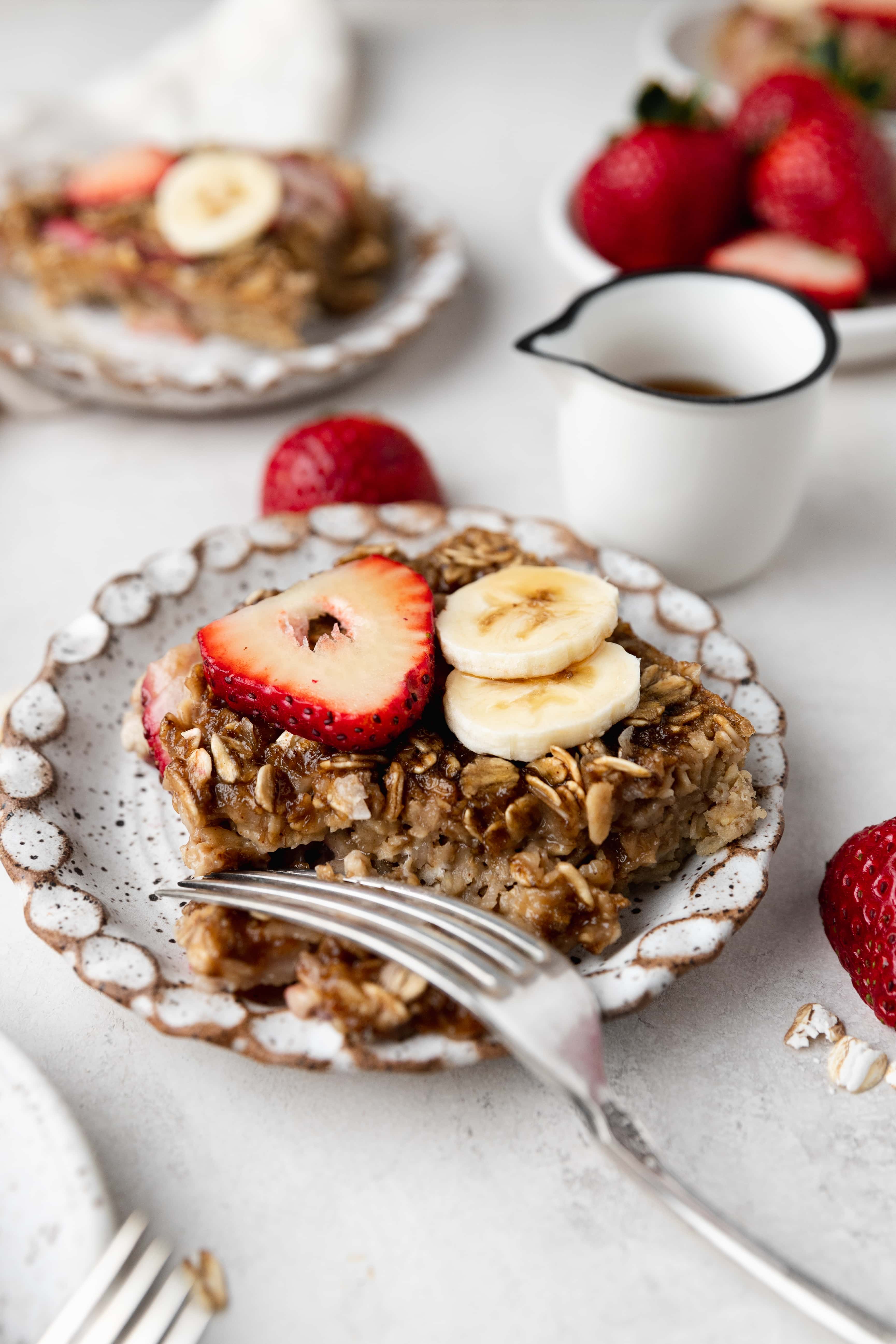 strawberry banana baked oatmeal on plate with fork