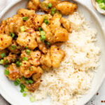 healthy orange chicken over rice with green onion