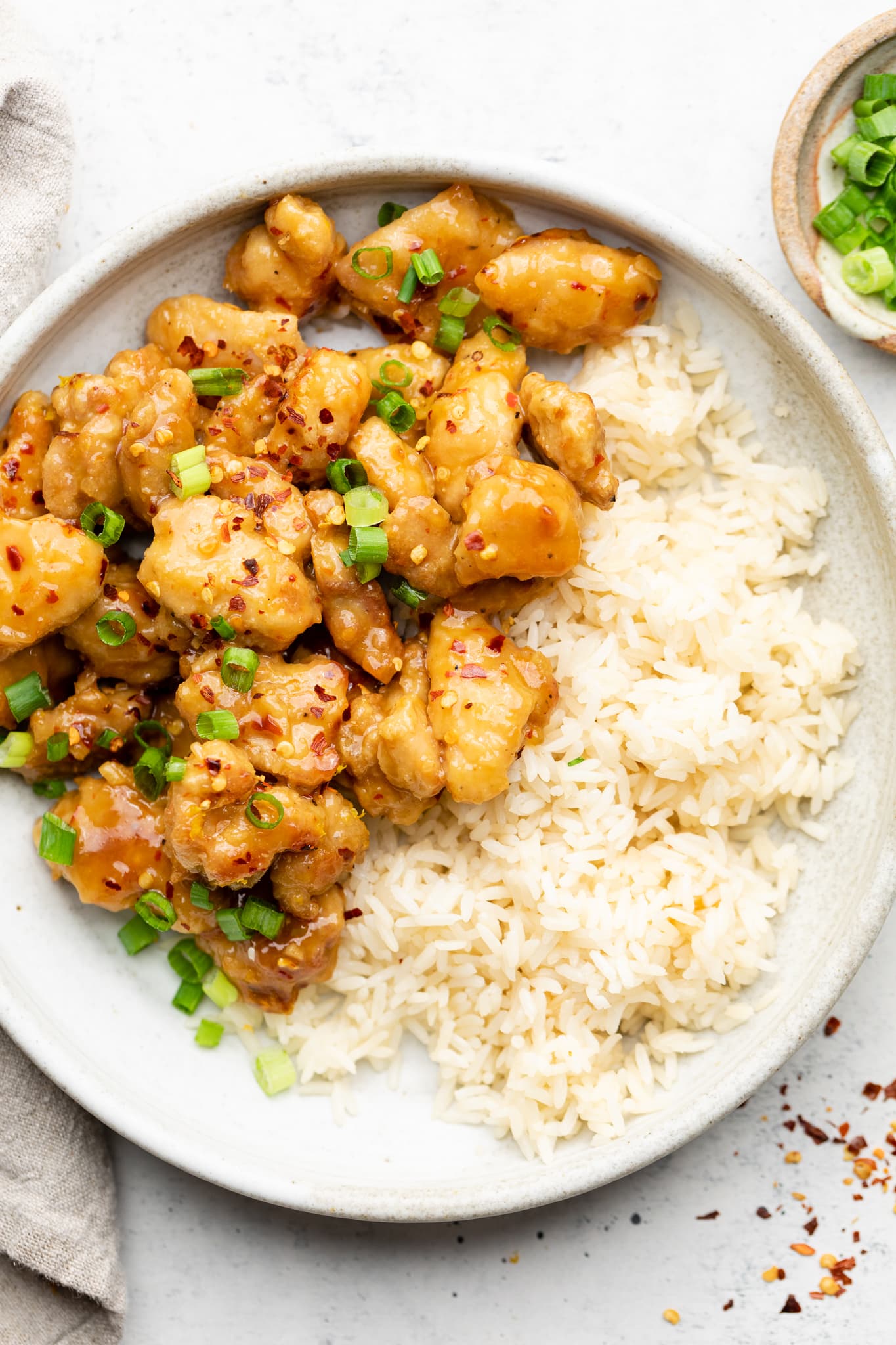healthy orange chicken over rice with green onion