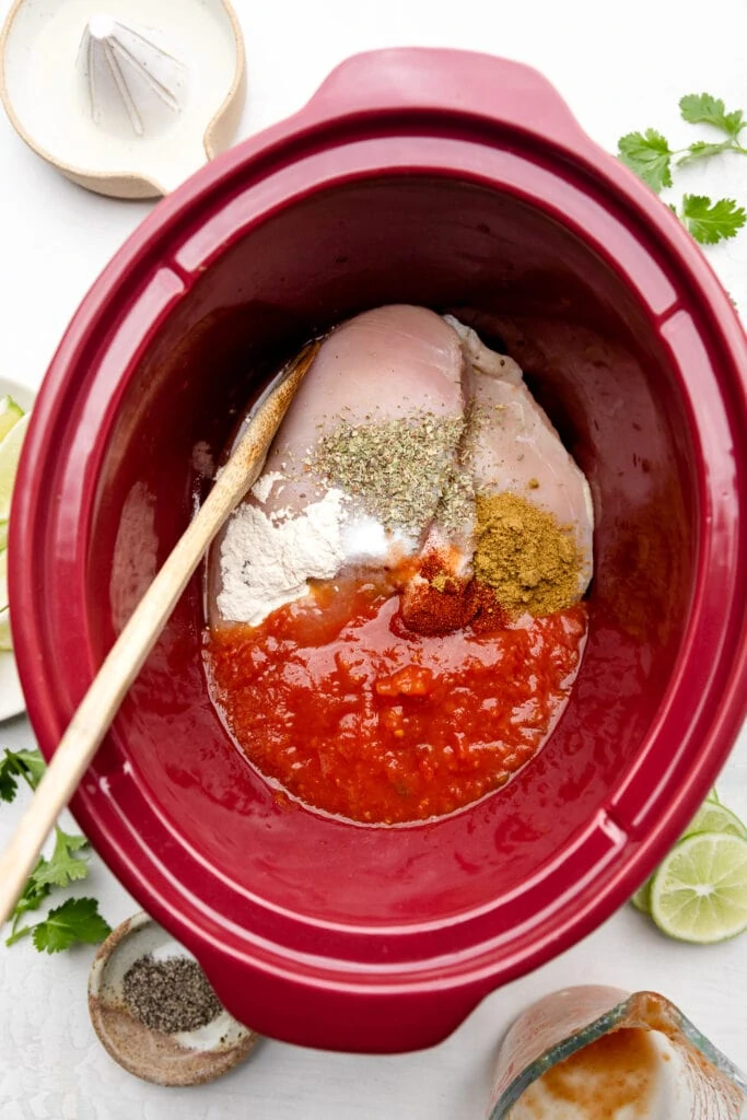 chicken, salsa, lime juice, and spices in slow cooker