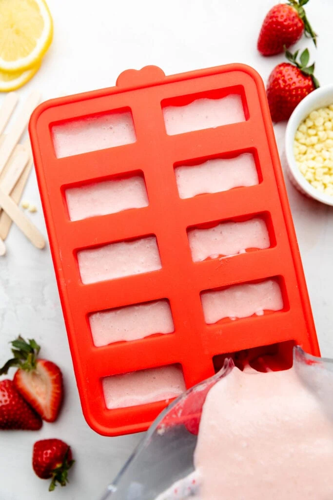 pouring mixture into popsicle mold