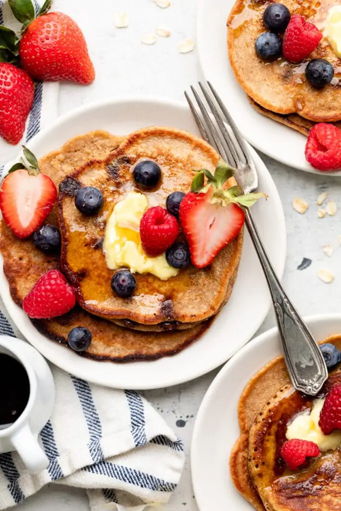 oatmeal pancakes on plate with fruit