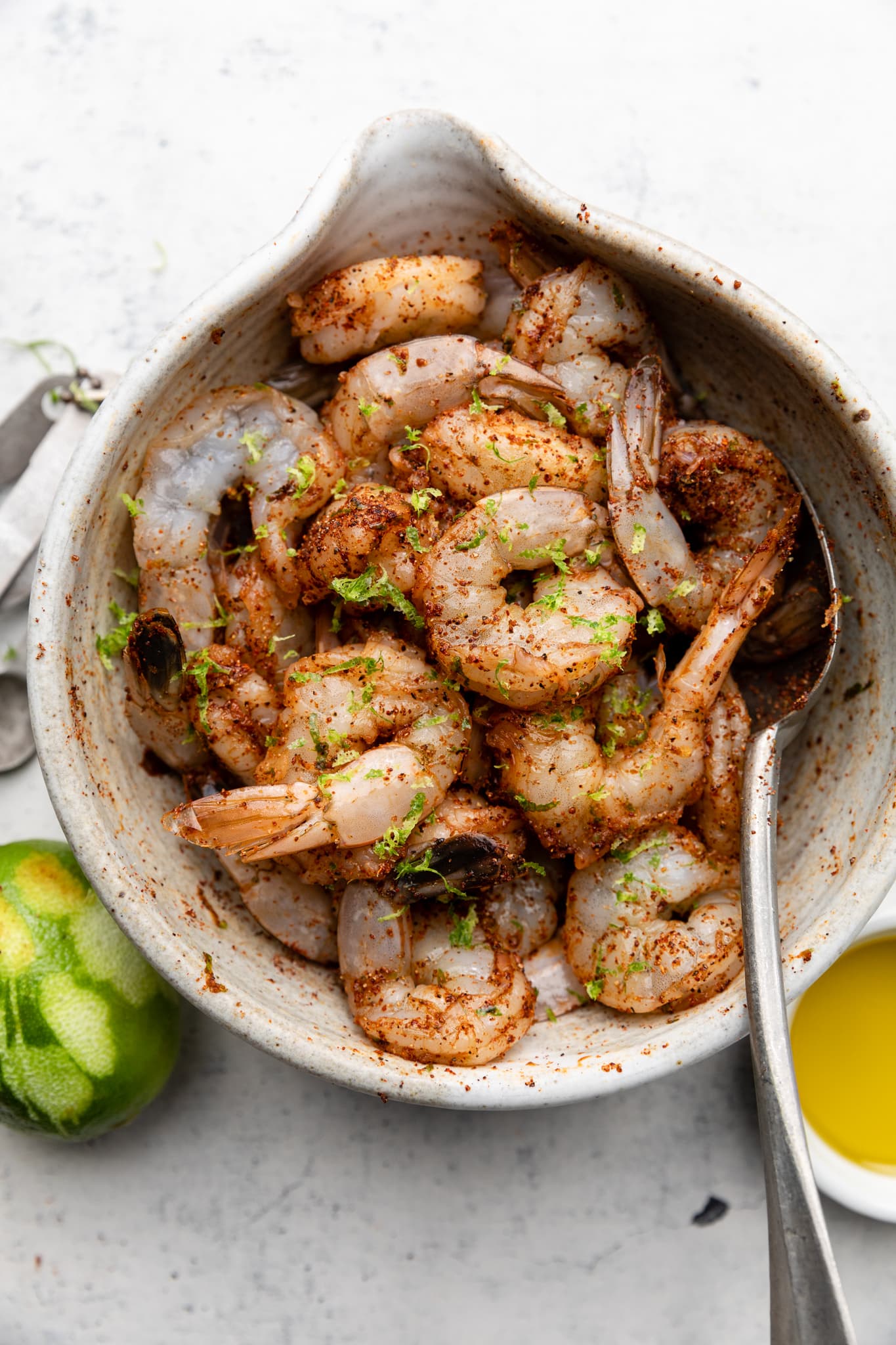 shrimp with seasonings in mixing bowl
