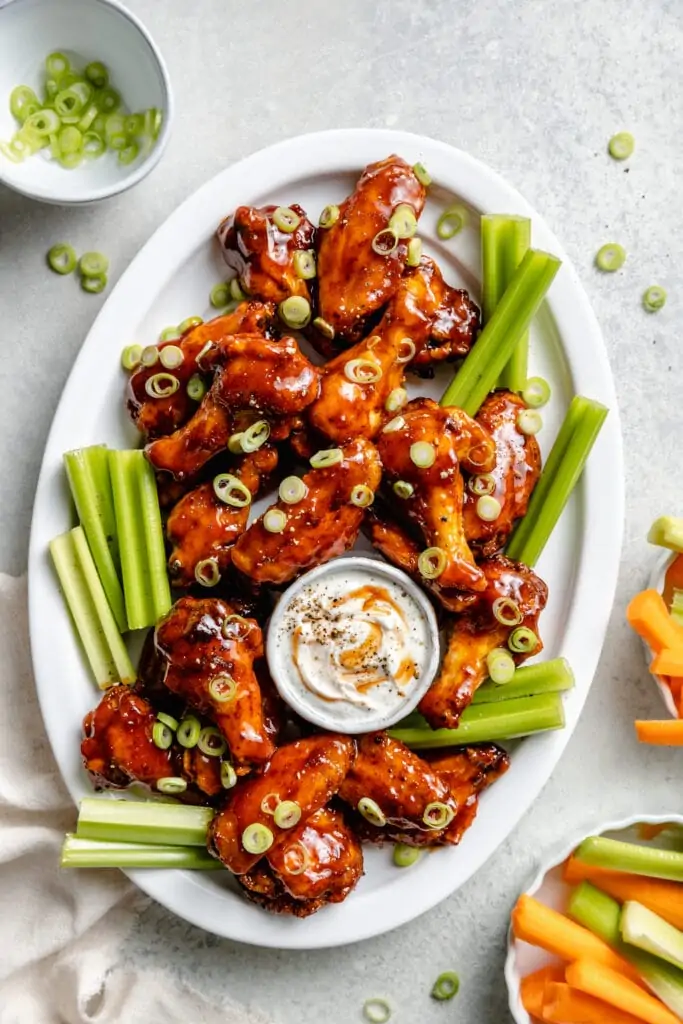 bbq chicken wings on platter with celery
