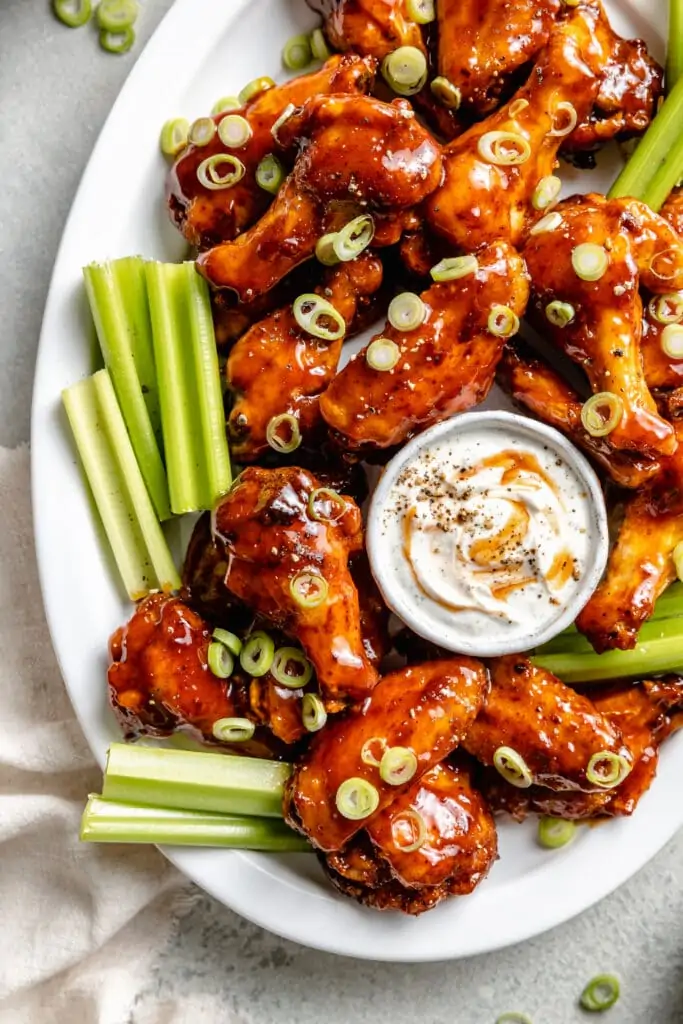 bbq chicken wings on platter with dip