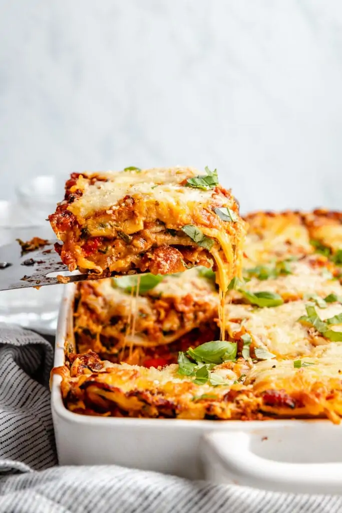 slice of lasagna being lifted out of pan