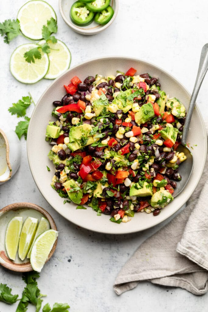 black bean and corn salad in bowl with spoon