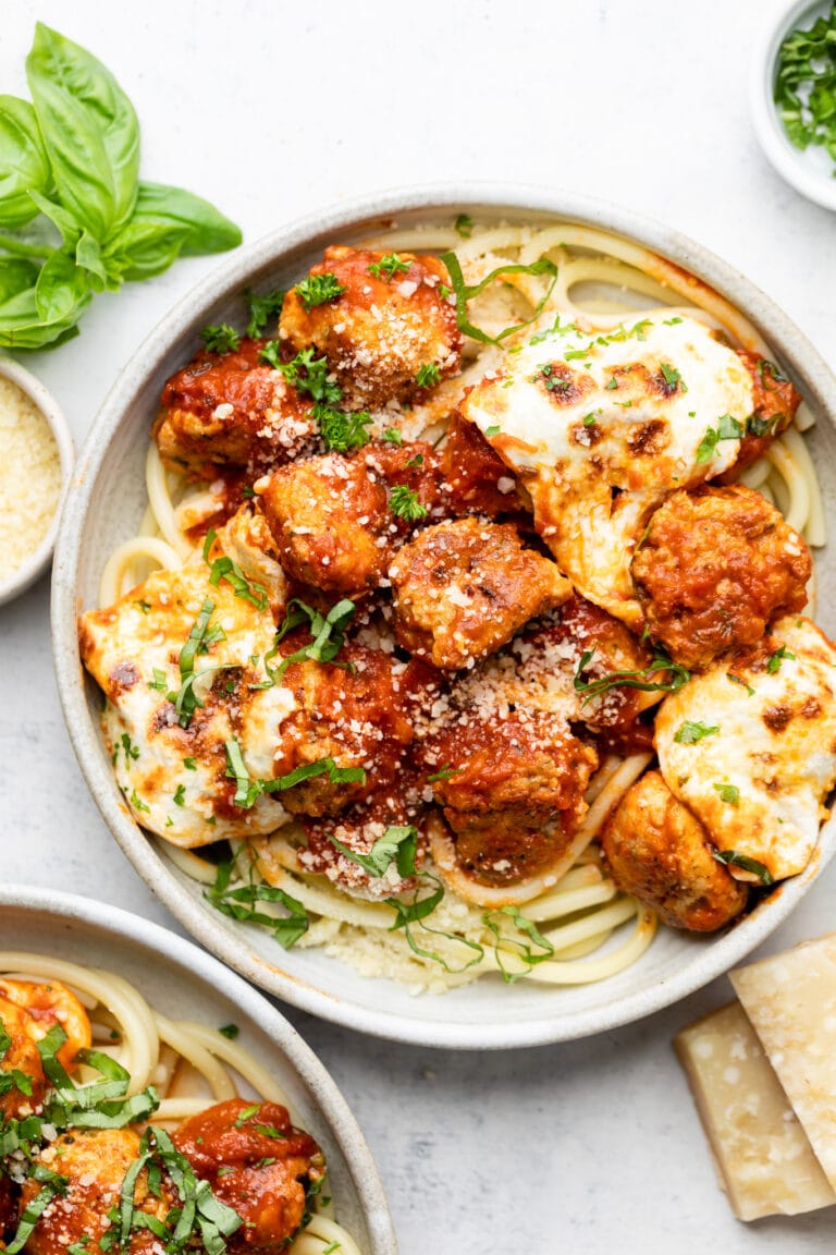 chicken parmesan meatballs in bowl over pasta
