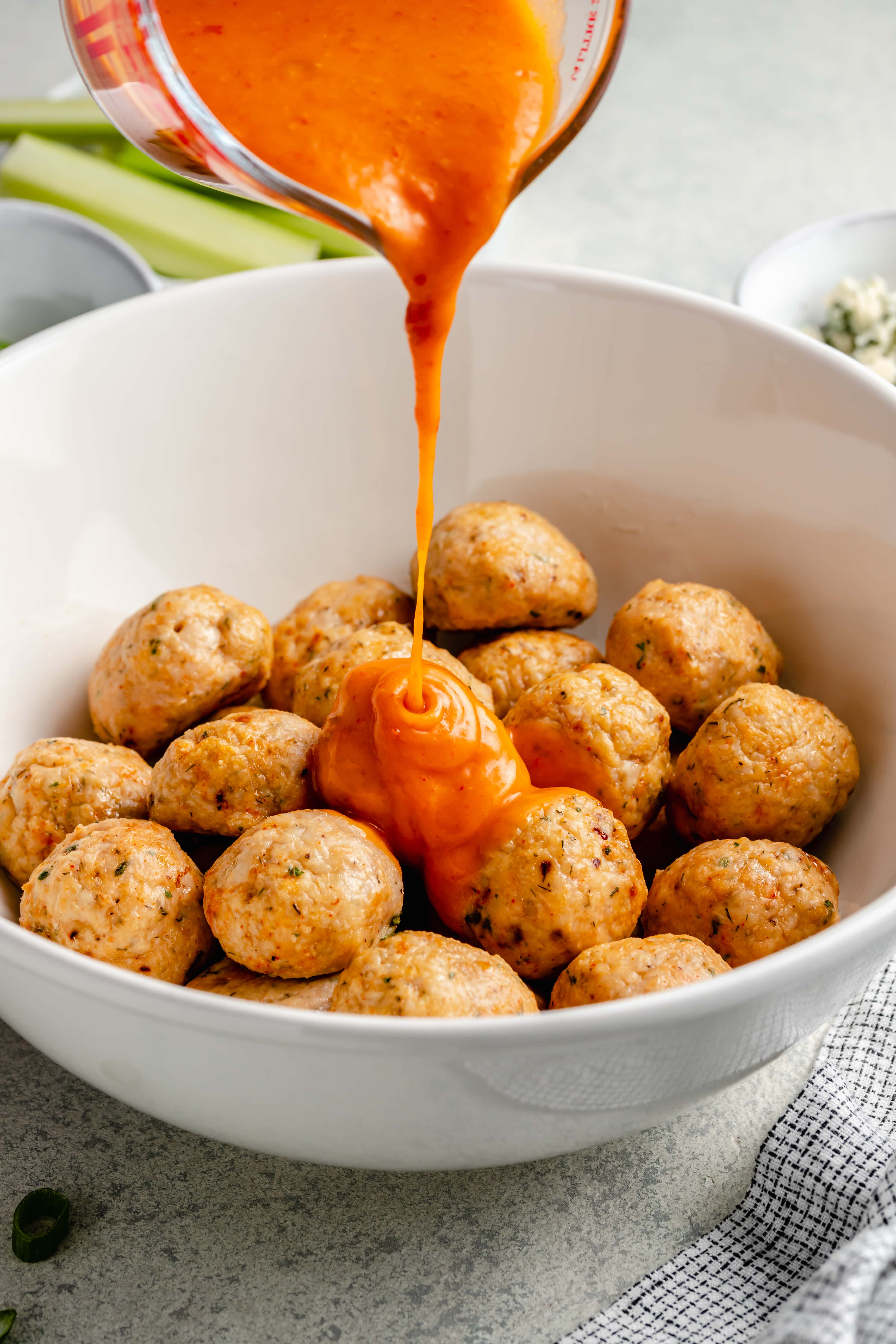 meatballs in bowl with buffalo sauce