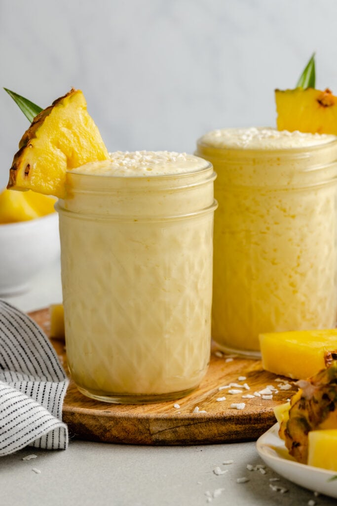 pina colada smoothie with pineapple on glass